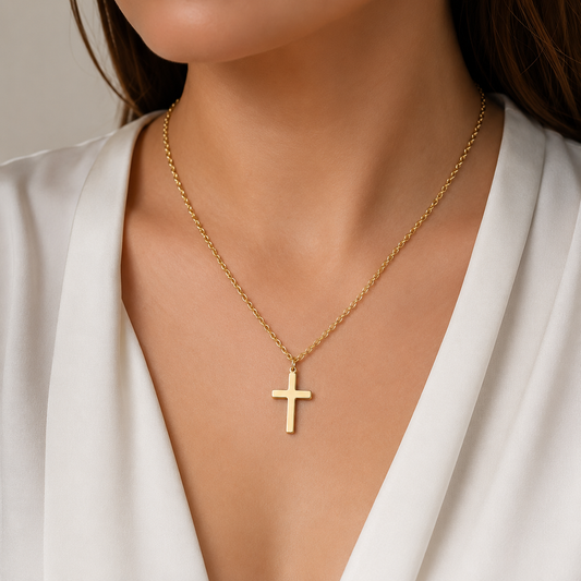 Woman wearing a gold-tone cross pendant necklace