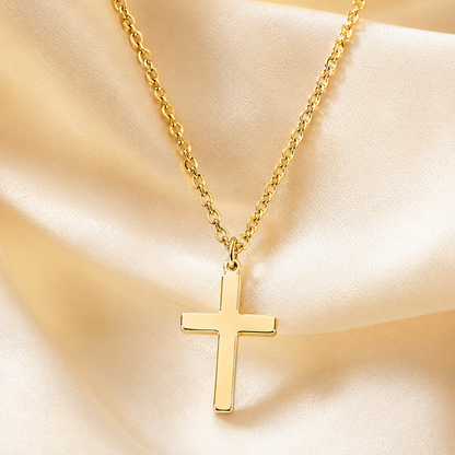 Close-up of gold-tone cross pendant and chain